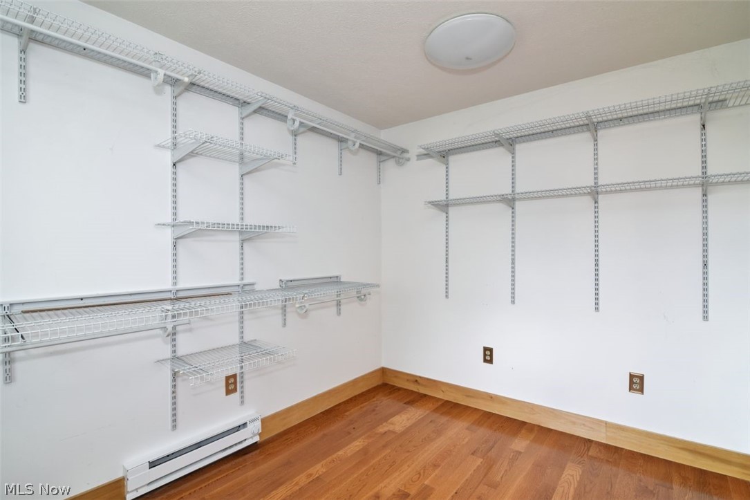 7251 Ryan Road Medina, OH 44256 - Photo 16 of 47 Room featuring extensive wire shelving storage solutions, hardwood flooring, and neutral wall tones