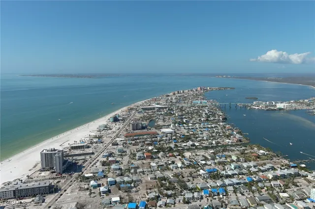 a view of a dry yard with wooden fence
