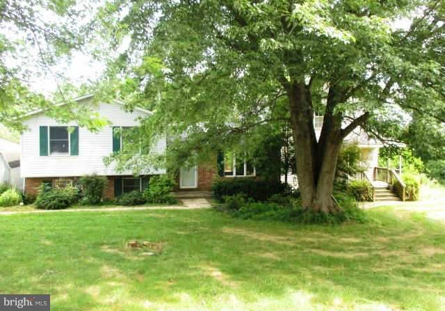 997 Ridge Road Finksburg, MD 21048 - Photo 1 of 7 a view of a backyard house with large trees and plants