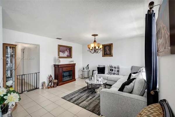 a living room with furniture ceiling fan and a rug