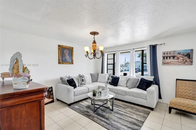 a living room with furniture ceiling fan and a rug