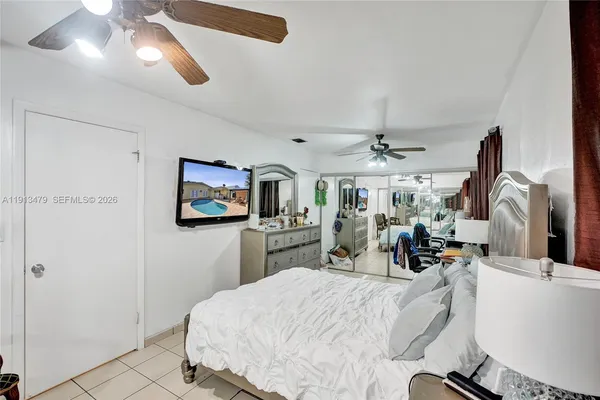 a bedroom with a bed and a white cabinet