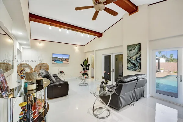 a kitchen with stainless steel appliances granite countertop a stove a sink dishwasher and white cabinets with wooden floor