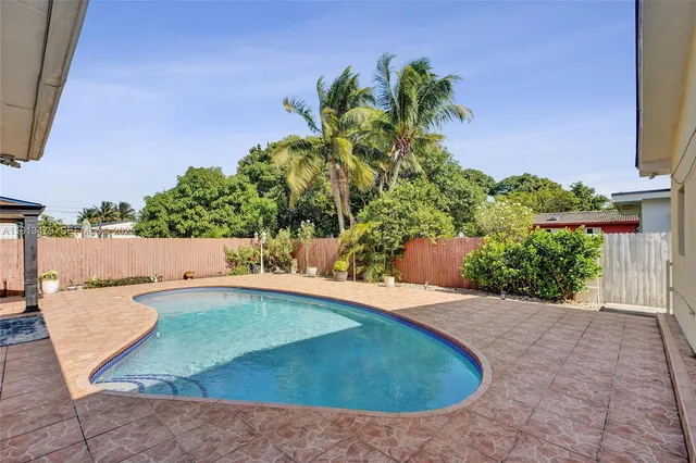 an aerial view of a house with garden space and street view
