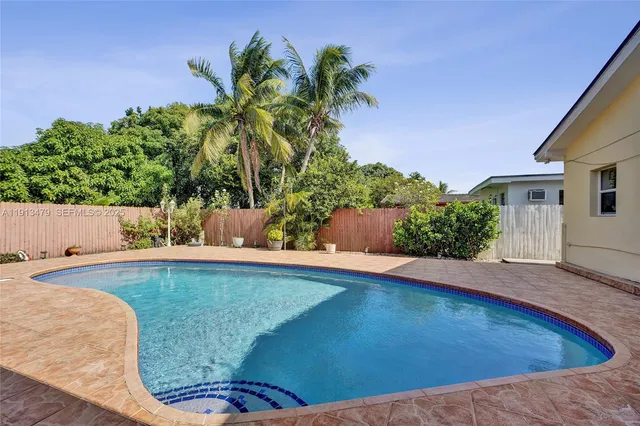 an aerial view of residential houses with outdoor space and river