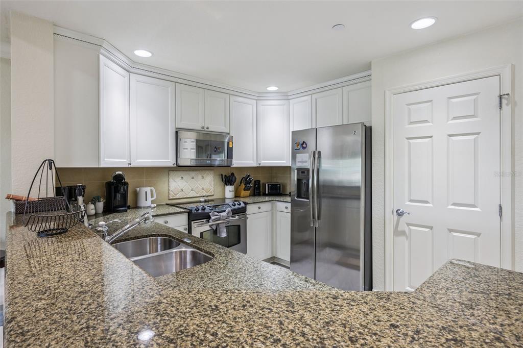 7602 Sandy Ridge Drive, Unit 103 Reunion, FL 34747 - Photo 12 of 61 a kitchen with a refrigerator sink and cabinets