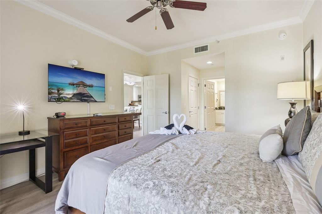 7602 Sandy Ridge Drive, Unit 103 Reunion, FL 34747 - Photo 15 of 61 a bedroom with a bed and a chandelier
