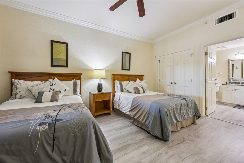 7602 Sandy Ridge Drive, Unit 103 Reunion, FL 34747 - Photo 16 of 61 a bedroom with a bed and a lamp
