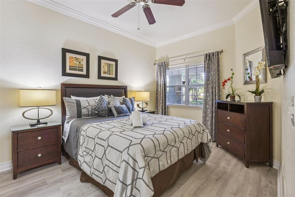 7602 Sandy Ridge Drive, Unit 103 Reunion, FL 34747 - Photo 17 of 61 a bedroom with a bed and a night stand