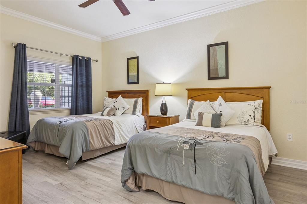 7602 Sandy Ridge Drive, Unit 103 Reunion, FL 34747 - Photo 23 of 61 a bedroom with two beds and painting on the wall