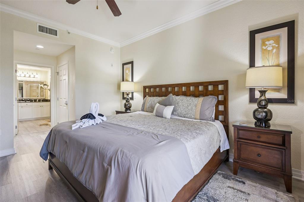 7602 Sandy Ridge Drive, Unit 103 Reunion, FL 34747 - Photo 25 of 61 a bedroom with a bed and wooden floor
