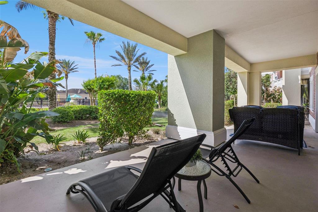 7602 Sandy Ridge Drive, Unit 103 Reunion, FL 34747 - Photo 30 of 61 a living room with furniture and a potted plant