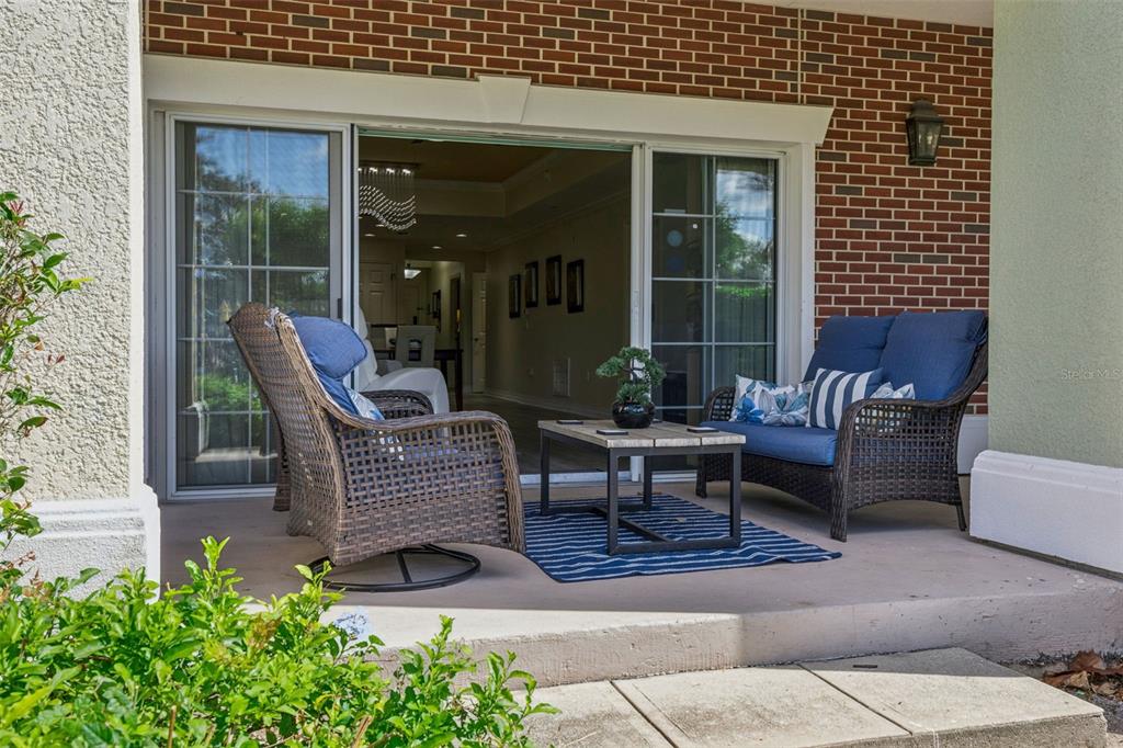 7602 Sandy Ridge Drive, Unit 103 Reunion, FL 34747 - Photo 32 of 61 a view of a patio with chairs and a table
