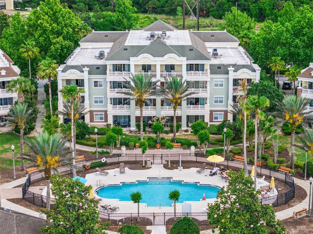 7602 Sandy Ridge Drive, Unit 103 Reunion, FL 34747 - Photo 36 of 61 a view of a building with garden and tall trees