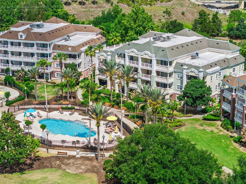 7602 Sandy Ridge Drive, Unit 103 Reunion, FL 34747 - Photo 37 of 61 an aerial view of multiple houses with yard