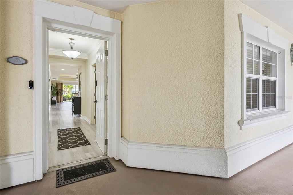 7602 Sandy Ridge Drive, Unit 103 Reunion, FL 34747 - Photo 7 of 61 a view of a hallway view with wooden floor and staircase