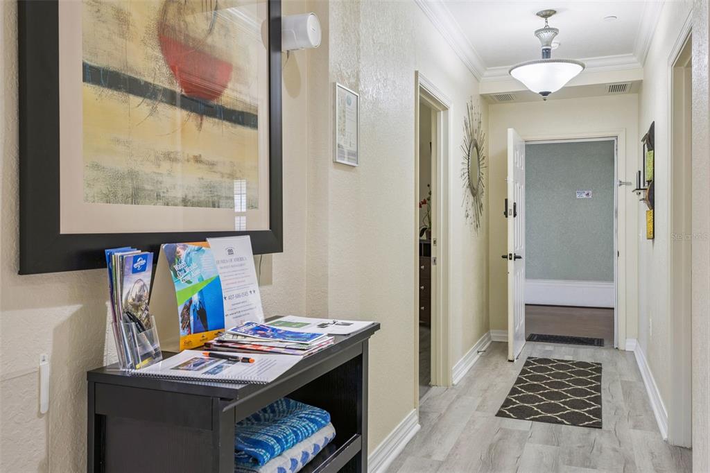 7602 Sandy Ridge Drive, Unit 103 Reunion, FL 34747 - Photo 8 of 61 a room that has a bed and a table in it