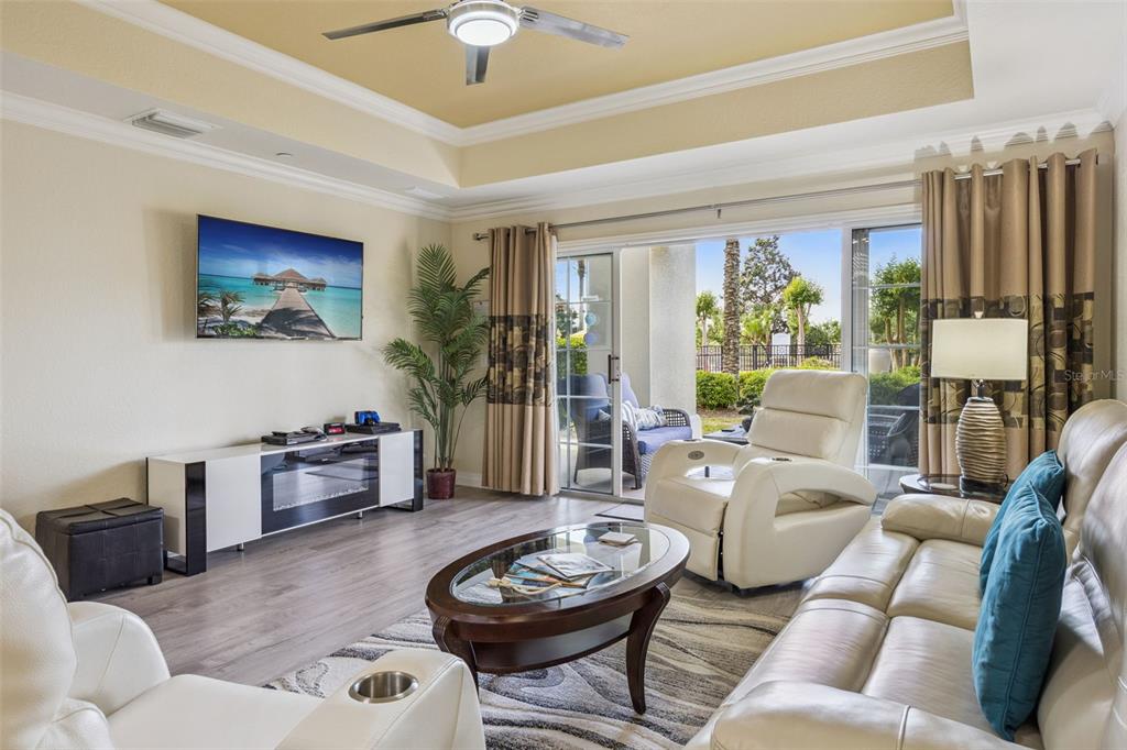 7602 Sandy Ridge Drive, Unit 103 Reunion, FL 34747 - Photo 9 of 61 a living room with furniture a rug and a large window