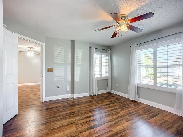 wooden floor in an empty room with a window