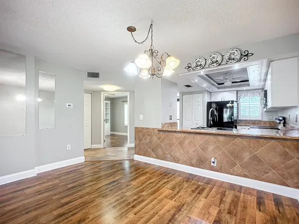 a bathroom with a granite countertop toilet a sink and bathtub