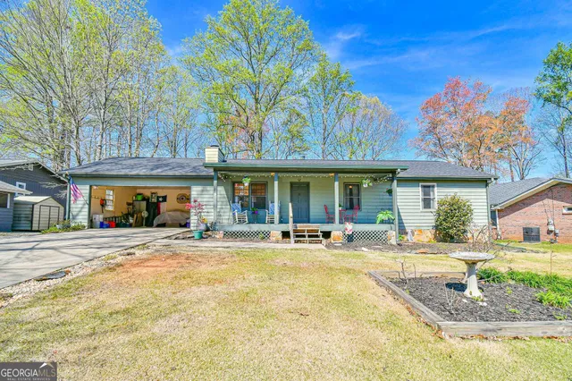 a front view of a building with street and trees