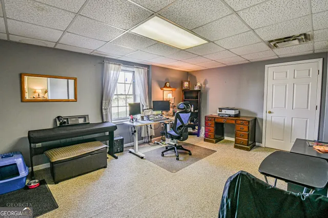 a view of a workspace with furniture and a window