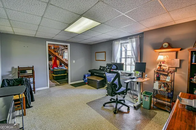 a view of a livingroom with workspace and a window