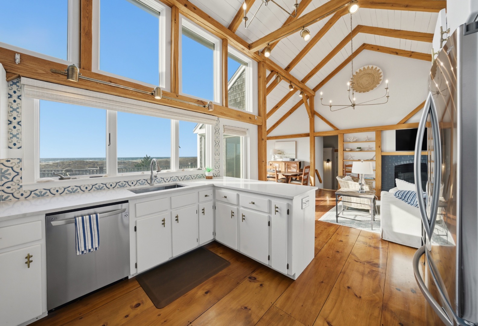 45 Sheep Pond Road Nantucket, MA 02554 - Photo 13 of 39 a large white kitchen with wooden floor and cabinets