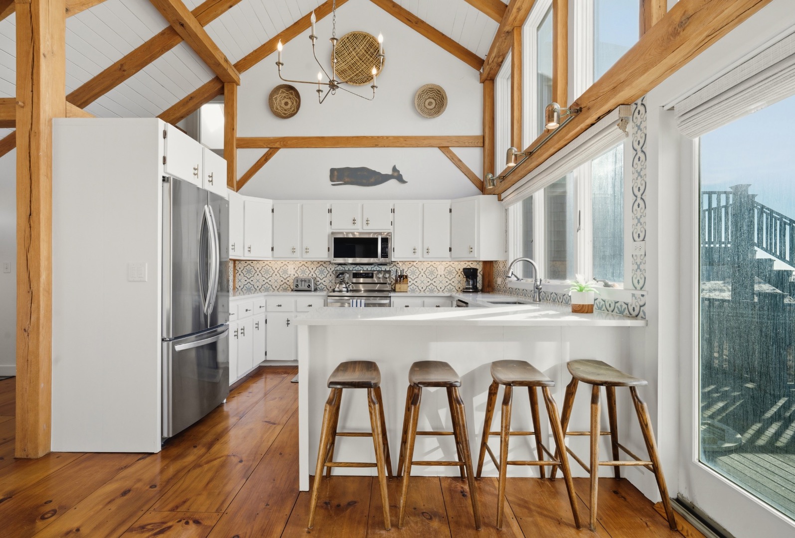 45 Sheep Pond Road Nantucket, MA 02554 - Photo 14 of 39 a kitchen with stainless steel appliances granite countertop a dining table chairs refrigerator and sink