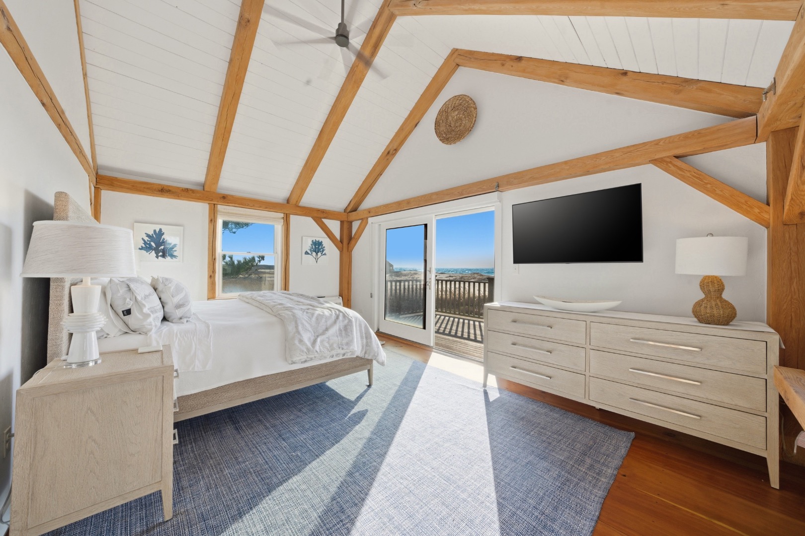 45 Sheep Pond Road Nantucket, MA 02554 - Photo 21 of 39 a bedroom with a large bed and a flat tv screen