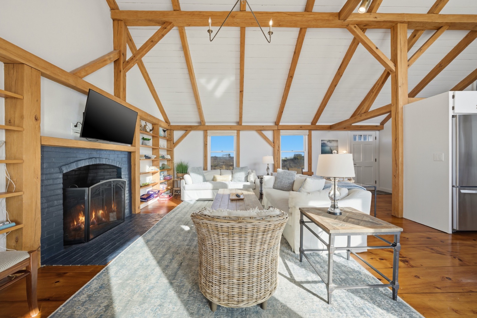 45 Sheep Pond Road Nantucket, MA 02554 - Photo 5 of 39 a living room with furniture a fireplace and a floor to ceiling window
