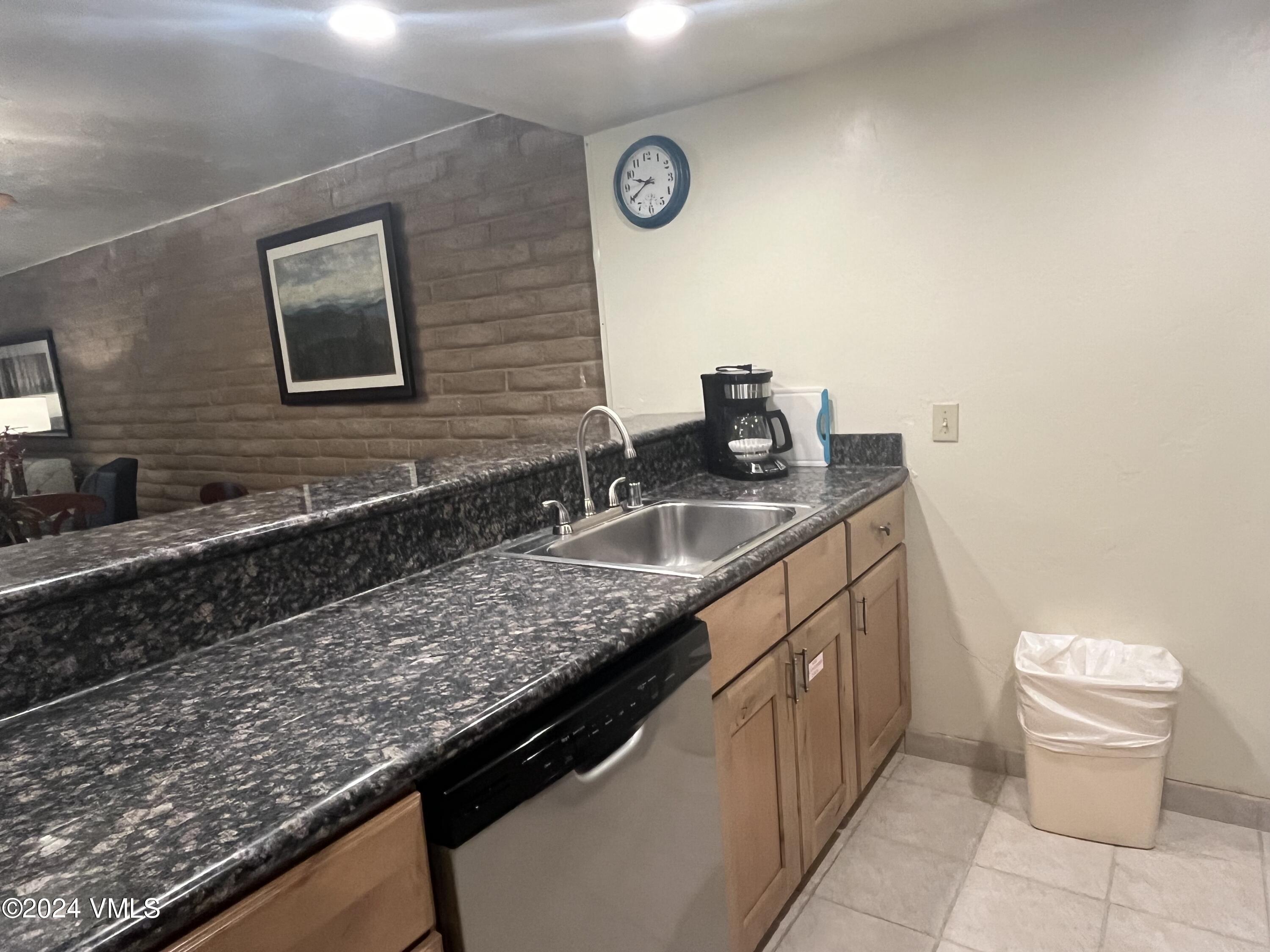 1020 Vail View Drive, Unit 330929 Vail, CO 81657 - Photo 3 of 21 a bathroom with a granite countertop sink a toilet and mirror