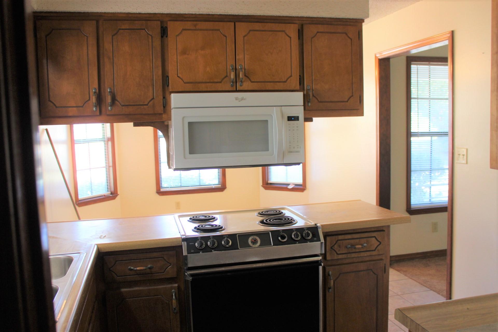 315 John King Road Crestview, FL 32539 - Photo 3 of 12 a kitchen with granite countertop a stove top oven cabinetry