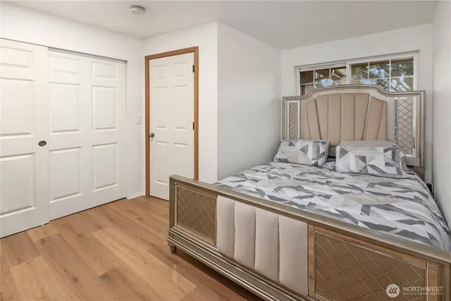 a bedroom with a bed and a window