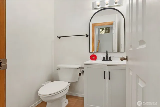 a bathroom with a sink mirror and toilet