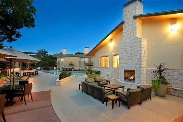 a building outdoor space with patio furniture and potted plants