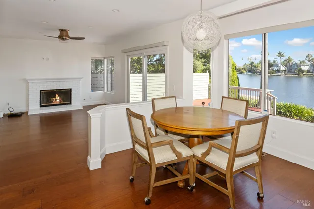 a living room with a fireplace and ceiling fan