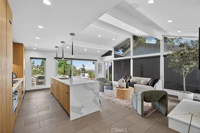 a living room with lots of furniture and a large window