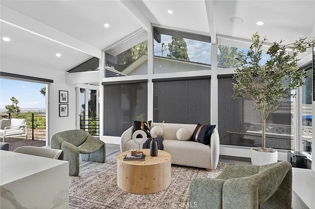 a kitchen with a table chairs refrigerator and cabinets