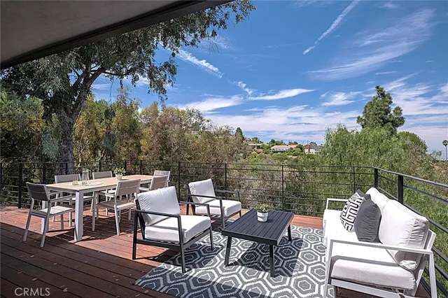 a bedroom with furniture and a flat screen tv