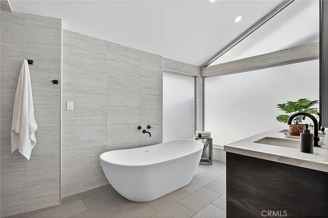 a view of an empty room with wooden floor and a shower