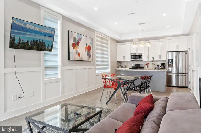 a kitchen with stainless steel appliances kitchen island granite countertop a refrigerator and microwave