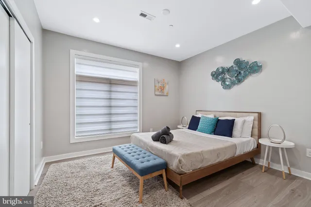 a bedroom with a bed and a painting