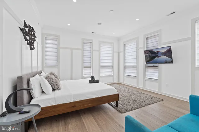 a large bedroom with a bed and a couch