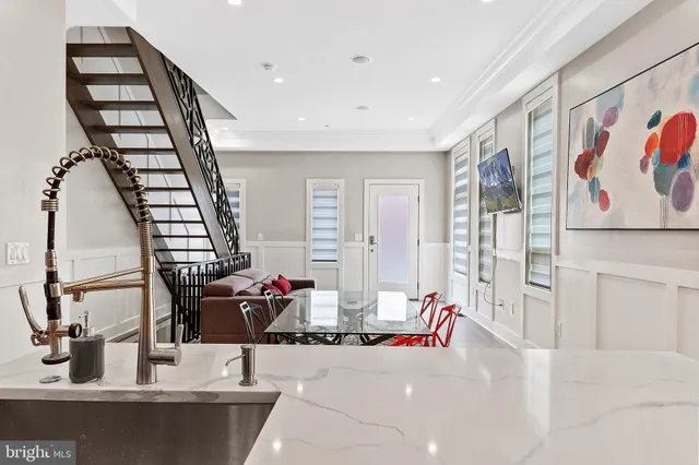 a living room with furniture and large mirror