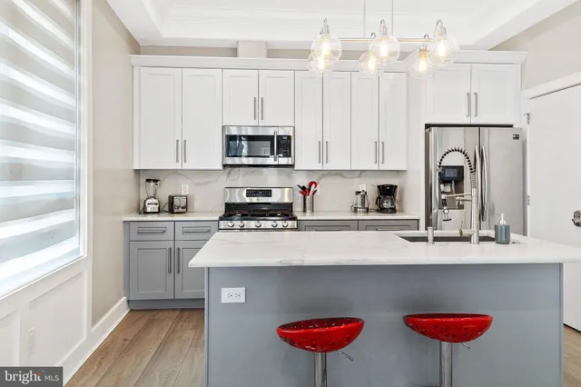 a kitchen with stainless steel appliances a white refrigerator sink and cabinets