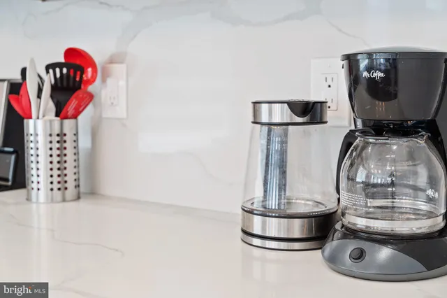 a kitchen with stainless steel appliances granite countertop a sink and a stove