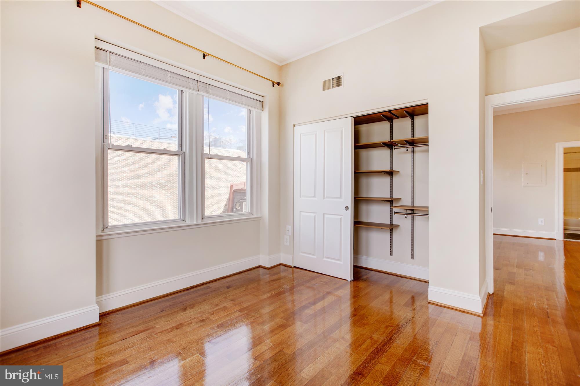 2008 16th Street Northwest, Unit 402 Washington, DC 20009 - Photo 11 of 34 a view of empty room with wooden floor and fan