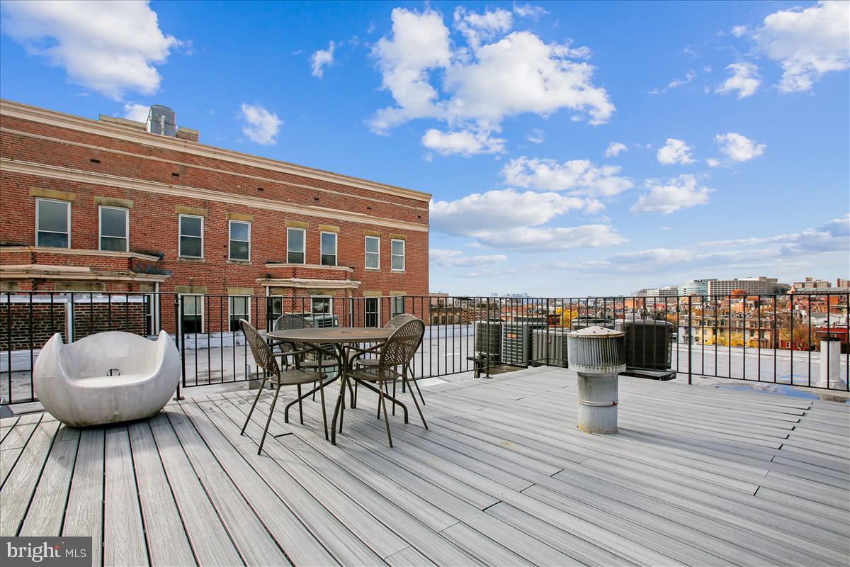 2008 16th Street Northwest, Unit 402 Washington, DC 20009 - Photo 24 of 34 a view of a roof deck with dining table and chairs with wooden floor