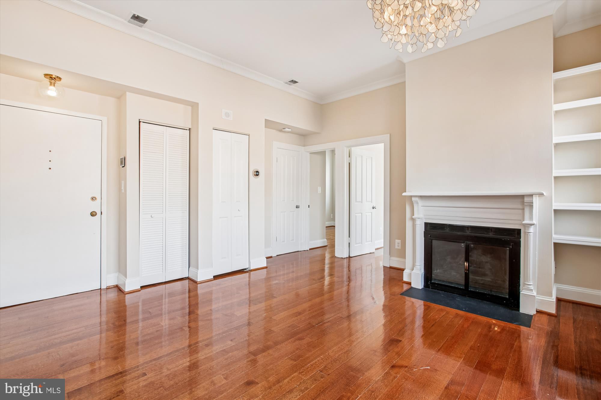 2008 16th Street Northwest, Unit 402 Washington, DC 20009 - Photo 7 of 34 a view of an empty room with wooden floor fireplace and a window